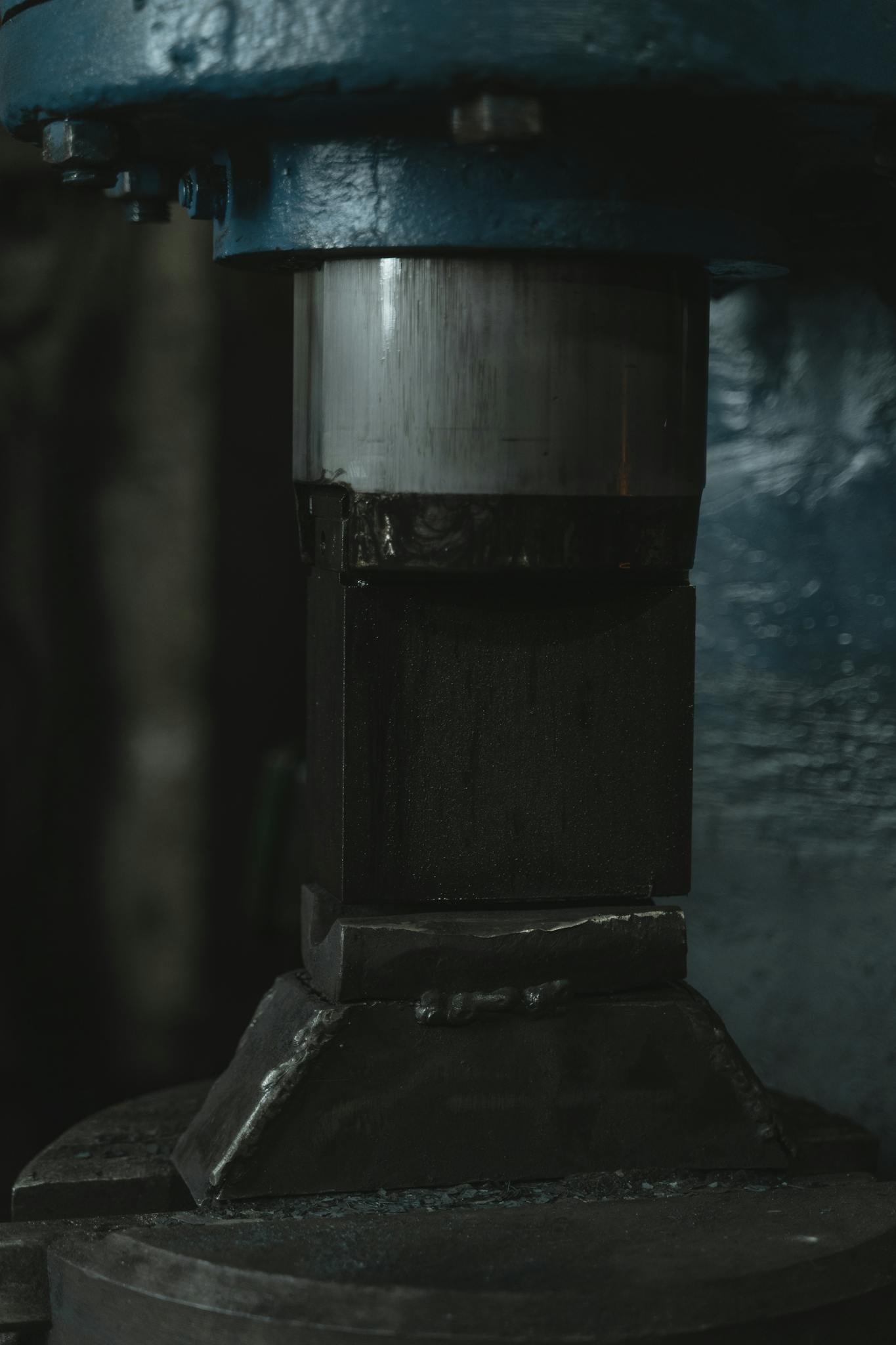 Close-up of heavy industrial forging equipment used for shaping metal in a workshop setting.